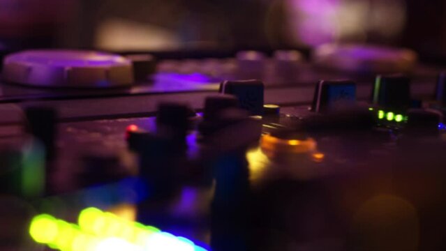 DJ Mixboard in the disco with bokeh light effects