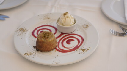 cupcake and ice cream on plate with sauce