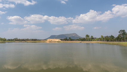 Fototapeta na wymiar Clear lake with a blue cloudy sky above
