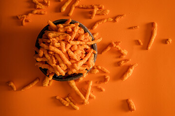 Fine cheese snacks in the basket with orange background