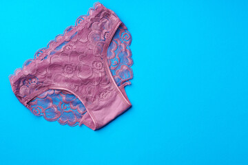 Women's panties on a blue background in studio
