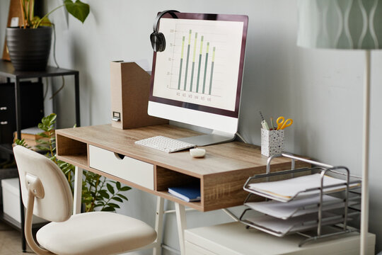Background image of home office workplace in white with PC computer on wooden desk, copy space