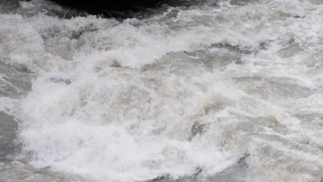 An old abandoned highway in the mountains. Muddy mountain river in a deep gorge. slow motion.