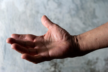 Older man's hands, anatomical detail, skin texture, expression and manual language, working man's hand.