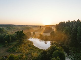 Beautiful view of the river at sunset surrounded by green vegetation.