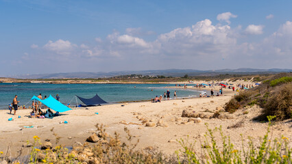 Fototapeta na wymiar Panoramic view of Dor Beach National Park at the end of Summer early Autumn. People enjoying the last warm days of Autumn. 