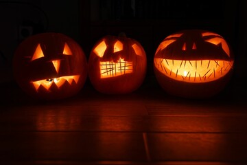 Pumpkin lanterns on a wooden background.