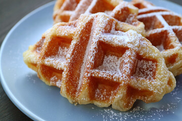 Closeup of Mouthwatering Croffles or Croissant Waffle Sprinkled with Powdered Sugar