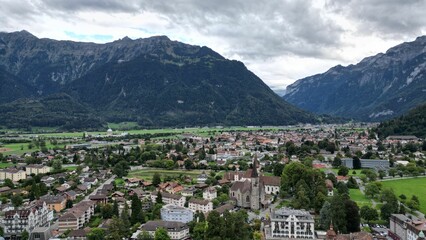 Fototapeta na wymiar View of a small town surrounded by mountains. Interlaken, Switzerland.