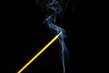 A yellow colored pencil touching the white smoke coming from bel