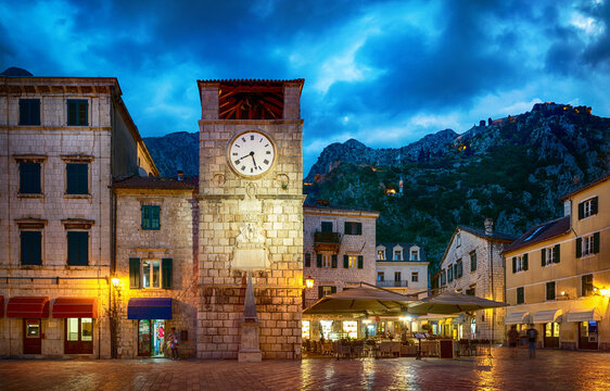 The clock tower on the army square at the entrance gate in the medieval city of Kotor. Evening view. Kotor, Montenegro