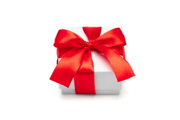 Close up shot of white present bow decorated with red satin ribbon tied bow, isolated over white background