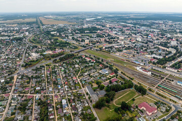 aerial panoramic view from great height of provincial town with a private sector and high-rise urban apartment buildings