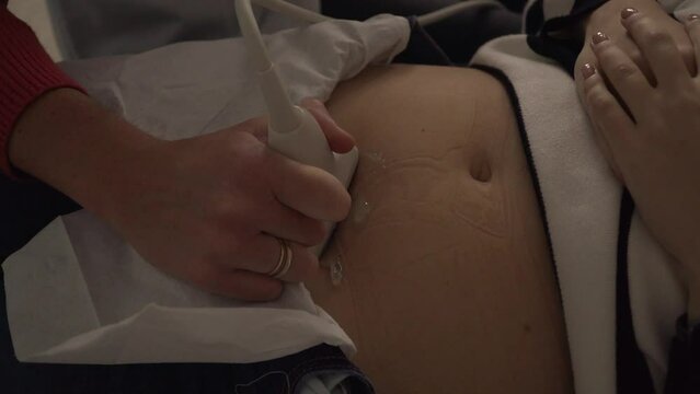 Doctor doing an ultrasound scan for a pregnant woman