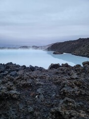 View from the rocky shore of blue lagoon in Iceland