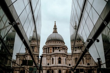 Fototapeta premium View of the St. Paul's Cathedral reflected on the glass of commercial buildings in London