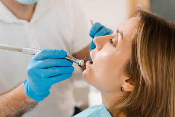 Dental drill close-up. Dentist drilling teeth of woman in dentistry clinic. Teeth treatment. Dental...