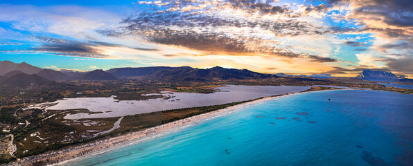Italy. Sardegnia (Sardinia) island nature scenery and best beaches. Aerial drone panoramic view of stunning La Cinta beach (San Teodoro) with turquoise sea and sault lake over sunset