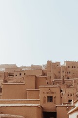 Close-up view of the old sandstone tower houses with light blue sky background