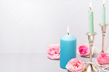 Floral still life  postcard. Fresh roses flowers and burning candles.