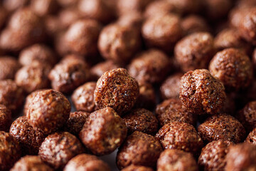 sweet crunchy chocolate children's breakfast chocolate balls on a white background