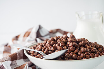 sweet crunchy chocolate children's breakfast chocolate balls on a white background