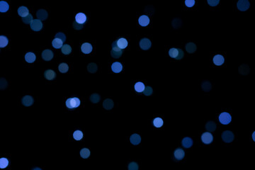 Blue round blurred bokeh lights for a festive background. defocused image