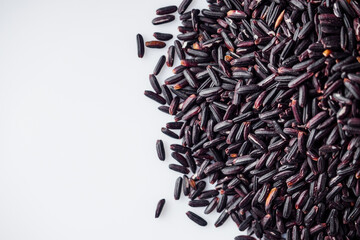 raw fresh black rice on a white background