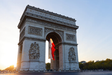 Fototapeta na wymiar The Triumphal Arch decorated with French flag, Paris, France