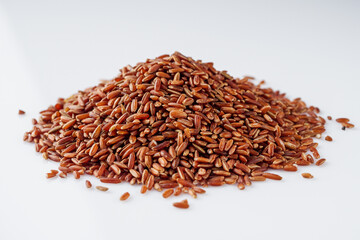 raw fresh red rice on a white background