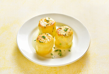 Fondant potatoes on plate