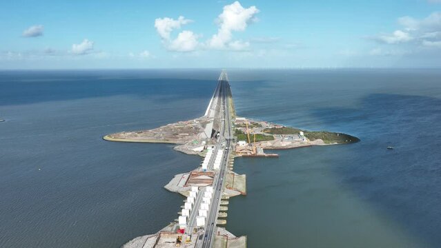 Afsluitdijk construction on pumping stations new sluices and the A7 near Den Oever, Kornwerderzand , and Zurich. Lock for shipping, road traffic cyclists and walkers. Aerial drone view.