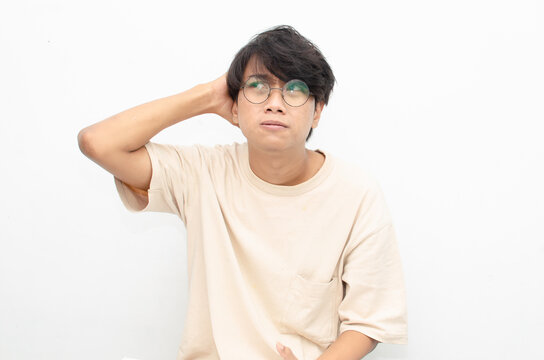 asian man looks depressed and messed up. Irritated man bites lips and scratches head. stressed over work concept.