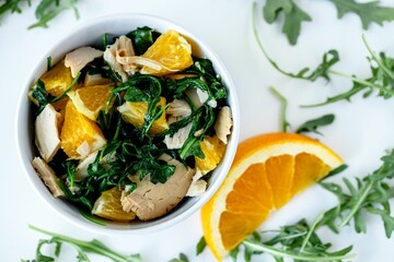 High angle closeup shot of an orange chicken salad on white surface