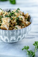 Selective focus Vertical High angle closeup shot of a chicken salad on marble surface
