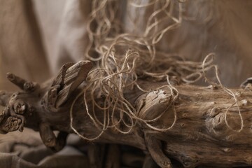 Natural fibers on a wooden log with jute linen background