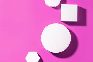 Mockup flat lay geometric shapes podium on a pink background. Top view blank for product presentation.