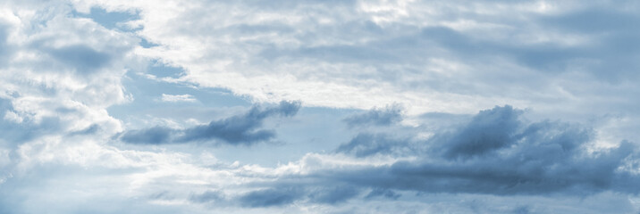 Picturesque sky with white and dark clouds of different shapes