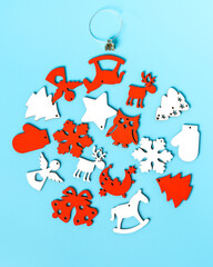 Christmas joy sign with retro baubles, winter flora and holiday season traditional symbols on blue background. View from above.