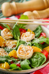 delicious fresh shrimp salad with orange and cherry tomatoes on a wooden rustic background