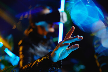 Closeup on woman in metaverse in vr goggles exploring