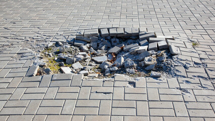 crater from a mine explosion on the bridge square of the city during the war in Ukraine © photosaint