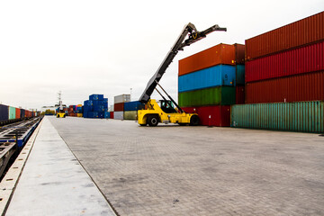 Forklift handling cargo container. Freight container loading. Container handler.  Logistics import export concept. Industrial container logistic yard.