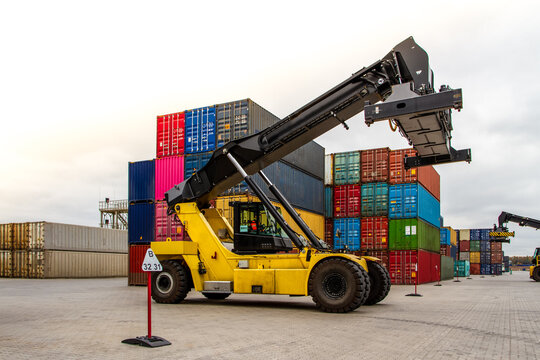 Container handlers. Forklift truck in shipping yard. Industrial container logistic yard. Logistics import export concept.