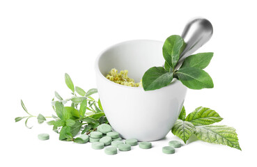 Mortar with different herbs and pills on white background