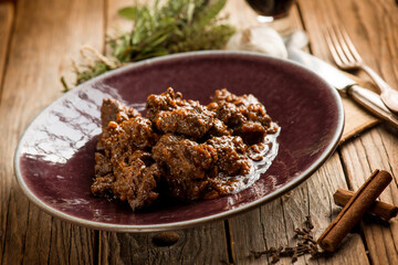 venison stew traditional italian recipe and glass of red wine