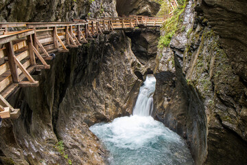 The beautiful view of Sigmund Thun Gorge - Sigmund Thun Klamm. Cascade valley of wild Kapruner Ache near Kaprun, Austria. Crystal clear blue water. Wooden hike trail path. 4K background, HD wallpaper.