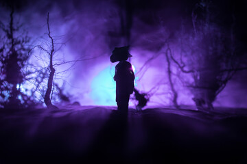 Silhouette of person standing in the dark forest. Horror halloween concept. strange silhouette in a...
