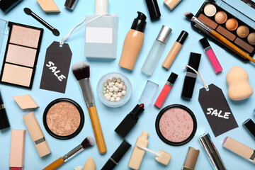 Cosmetics, accessories and sale tags on blue background