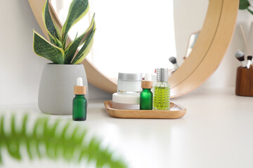 Different cosmetic products on table in room